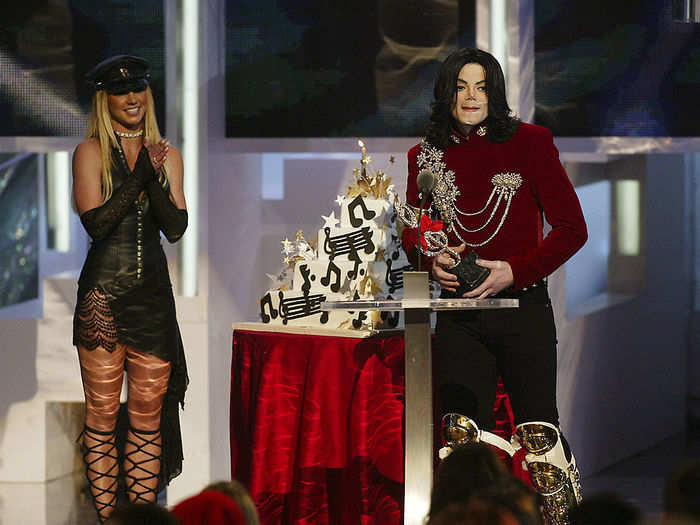 Britney Spears wore a leather outfit as she presented Michael Jackson with a birthday cake, which he initially thought was an "artist of the millennium" award.