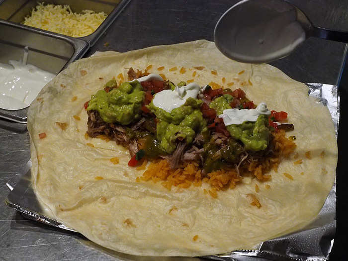 Beyond just making the difference in terms of flavor composition, laying out the ingredients in a linear fashion makes rolling the burrito far easier.