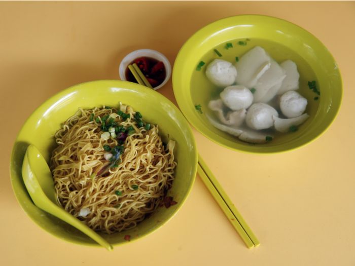 Fish ball noodle soup is served piping hot with a side of chilis for an extra kick.