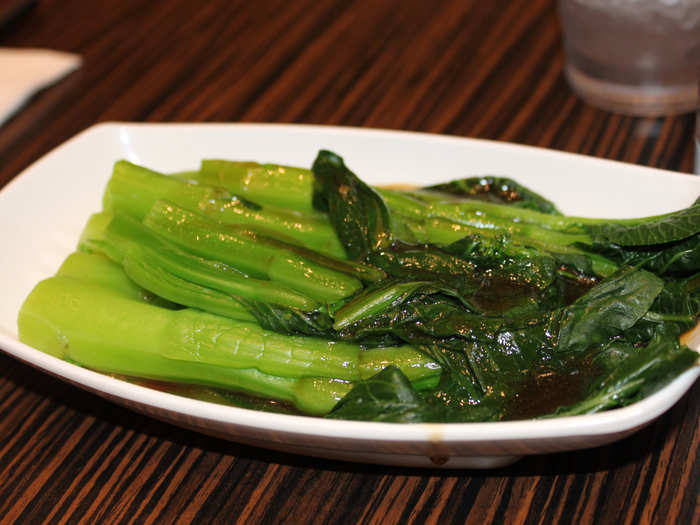 Bok choy is served in a garlicky brown sauce as a green side dish.