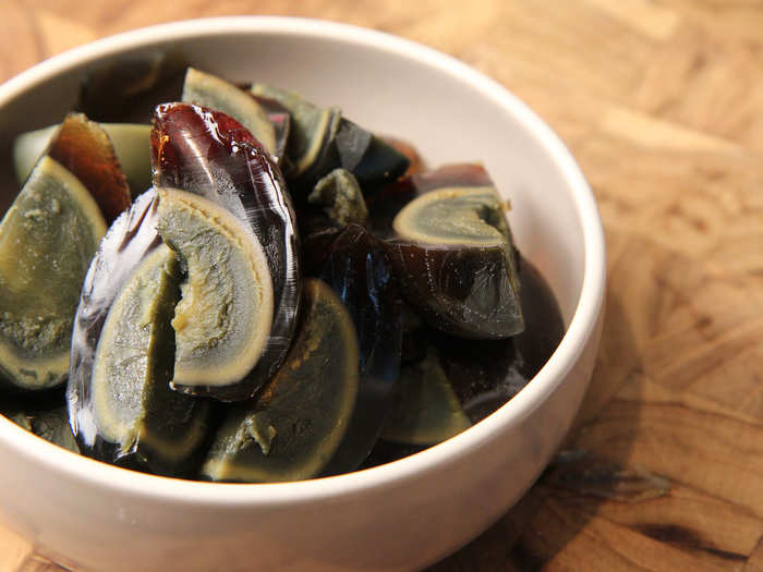 CHINA: A century egg, also called a hundred-year egg or thousand-year egg, is an egg that has been preserved in a saline solution for several weeks or months resulting in a creamy yolk and jelly outside.