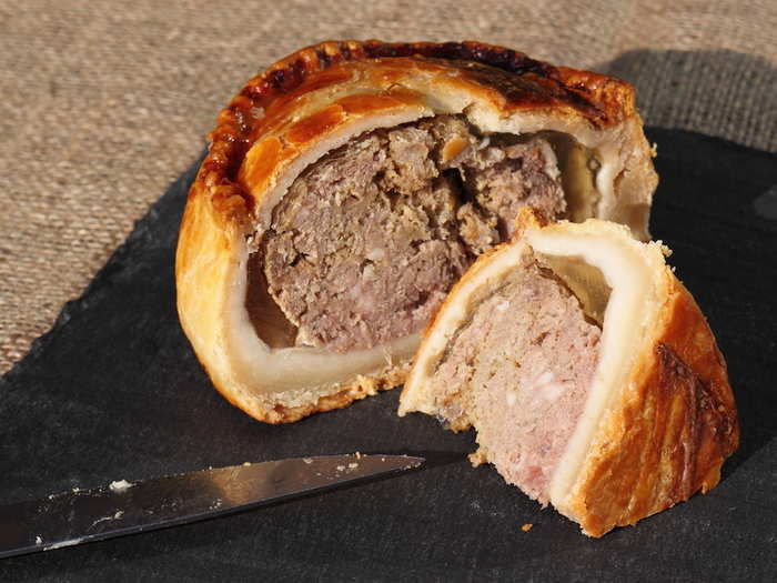 Pork pies are ideal for picnics and pub snacks, but are an acquired taste for non-Brits. Roughly-chopped pork is coated in pork jelly before being wrapped in a hot water crust pastry and baked.