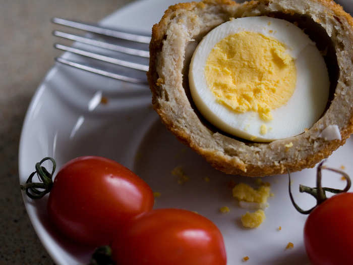 Scotch Eggs may look unusual, but they are a signature snack in most British pubs. A hard-boiled egg is encased in sausage meat before the whole thing is rolled in breadcrumbs and baked or deep-fried.