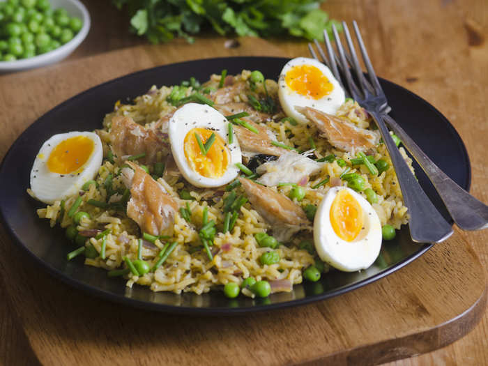 Kedgeree is descended from Kichari, a traditional Indian dish that mixes rice and vegetables. The British version features smoked fish like mackerel, boiled eggs, peas, and herbs.