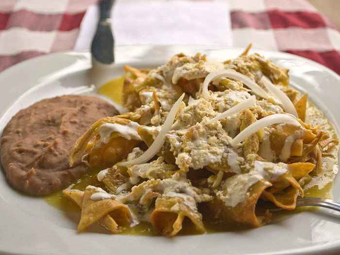 Chilaquiles are lightly fried tortilla chips covered in an array of sauces (either green salsa or red salsa, sometimes mole). Chicken, cheese, and various other toppings can also be added.