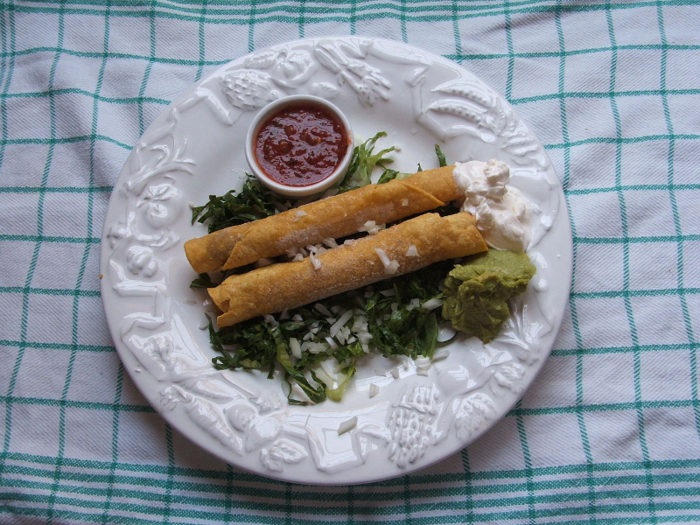 Flautas, also known as taquitos, are rolled, fried tortillas stuffed with filling, often some sort of meat or cheese. They can be topped with various salsas, sour cream, lettuce, and guacamole.