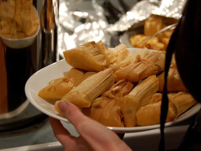 Tamales are masa filled with meats, cheeses, or veggies, which are wrapped in individual corn husks and steamed. Make sure you take the corn husk off before eating.