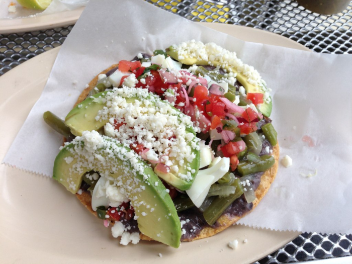 Tostadas are fried tortillas topped with anything you want. Popular toppings include beans, beef, pork, or fish, avocado, lettuce, tomatoes, and queso fresco.