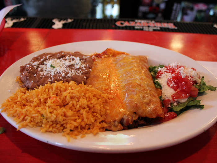 Enchiladas are corn tortillas filled with pretty much anything — meat, cheese, veggies, beans, etc. — and rolled shut. They are topped with sauces like salsa or mole, as well as cheese.