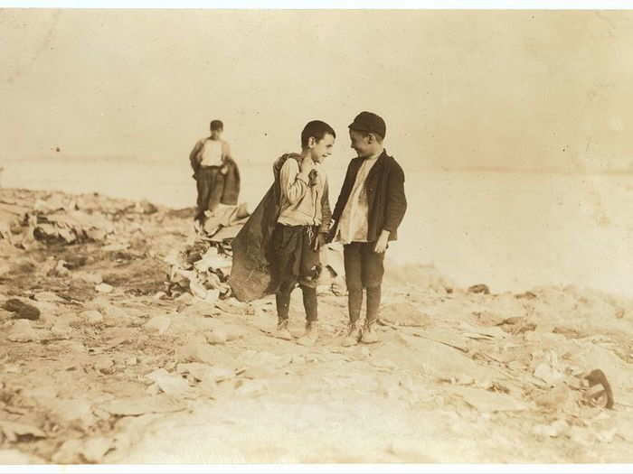 Boys picking over garbage on "the Dumps." Location: Boston, Massachusetts, October 1909.