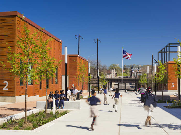 The Henderson Hopkins School in Baltimore, Maryland is for pre-school through grade eight students. It features a cluster of numbered buildings inspired by East Baltimore’s brick row houses.