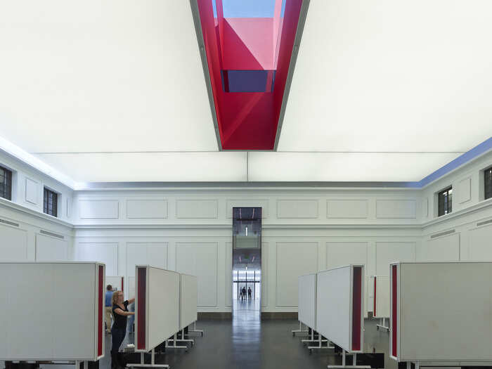 A slender skylight adds natural light to this workspace, which includes massive white boards.