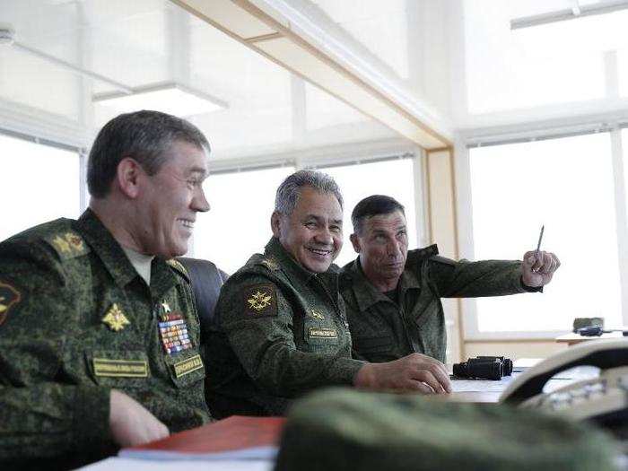Russian Defense Minister Sergei Shoigu, center, the head of General Staff, Gen. Valery Gerasimov, left, and the head of the main directorate of combat training Lieutenant-General Ivan Buvaitsev also made appearances at the Black Sea coast in Crimea.
