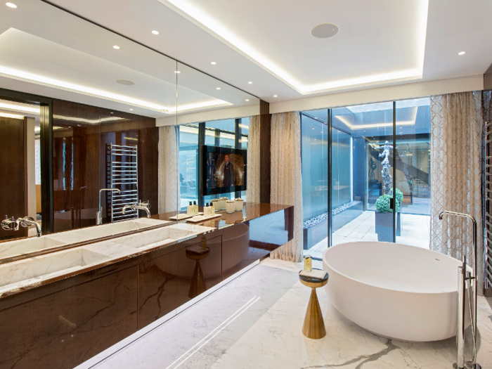 Features in the bathrooms include Maron stone flooring and walls, oak panelling, and marble double basins.