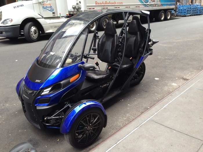 The SRK is basically a tandem 3-wheeled motorcycle/maxi-scooter that can be operated open or with an enclosure. It has a pair of electric motors, one for each front wheel. Arcimoto says the top speed is 85 mph, with a range of 70 miles. That range can be bumped to 130 miles with an upgraded battery. The SRK can be charged at 110V or 220V, and owners can by a "briefcase" charger if they don