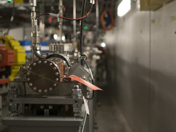 As the electrons go around turns in the storage ring, they decelerate slightly, losing energy. The lost energy can be converted into different forms of electromagnetic radiation, such as X-rays, that are directed down beamlines running in straight lines tangential to the storage ring. At the end of the beamline, the X-rays crash into samples of whatever material is the subject of the experiment.