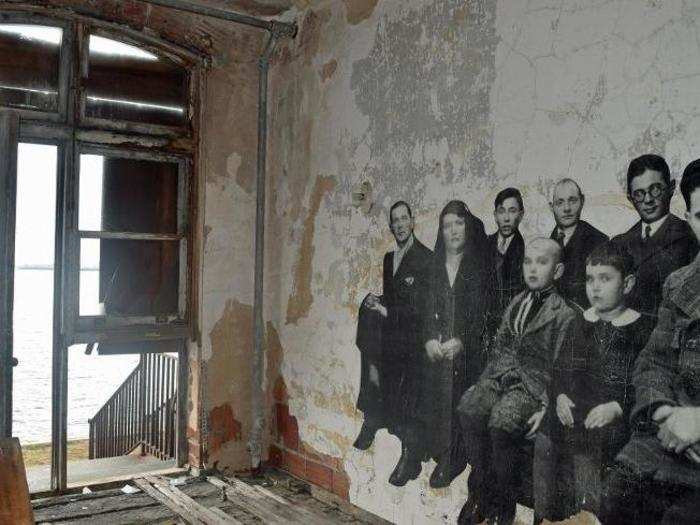 The artist took archival photographs from Ellis Island and superimposed them over crumbling facades in the abandoned hospital. There are two dozen of these photos installed around the grounds.