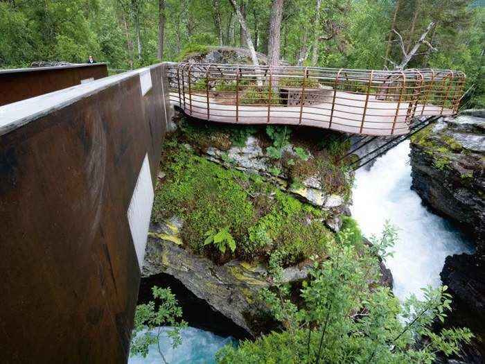 To reach some of the pods, guests need to traverse this curved, steel bridge that hovers above the rapids.