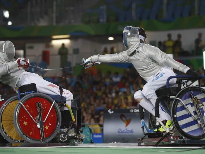 Vasileios Ntounis Greece competes with Tian Jianquan of China in fencing.