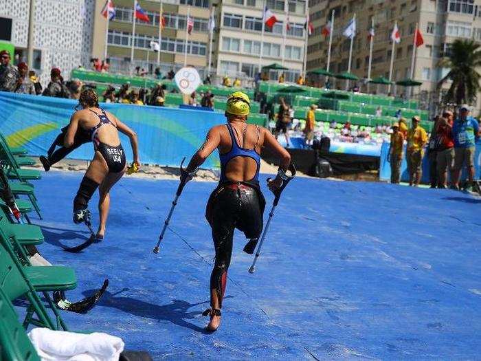 Competitors race up the beach in the women