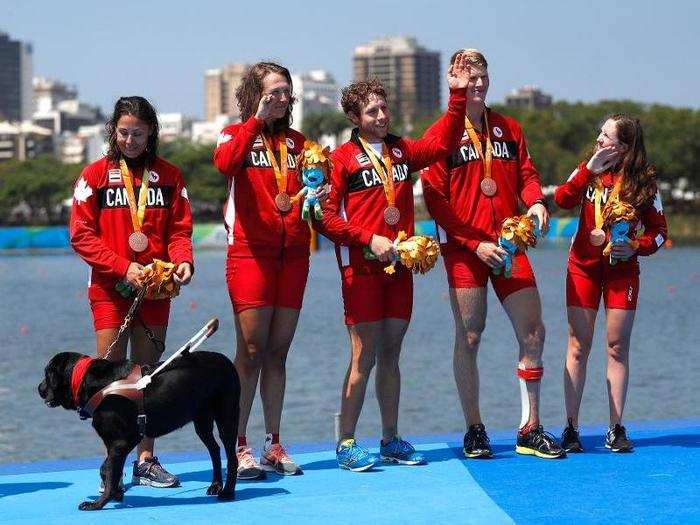 Members of Team Canada pose with their bronze medals in rowing.