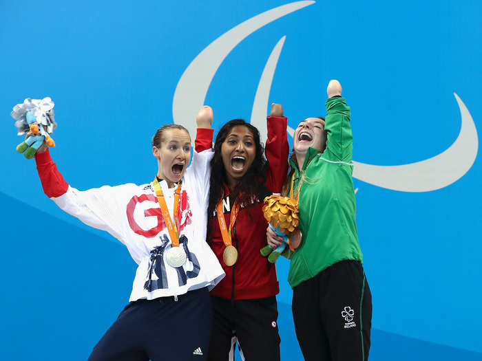 Silver medalist Claire Cashmore of Great Britain (left), gold medalist Katarina Roxon of Canada (center), and bronze medalist Ellen Keane of Ireland (right) celebrate their medals won during the 100-meter breaststroke.