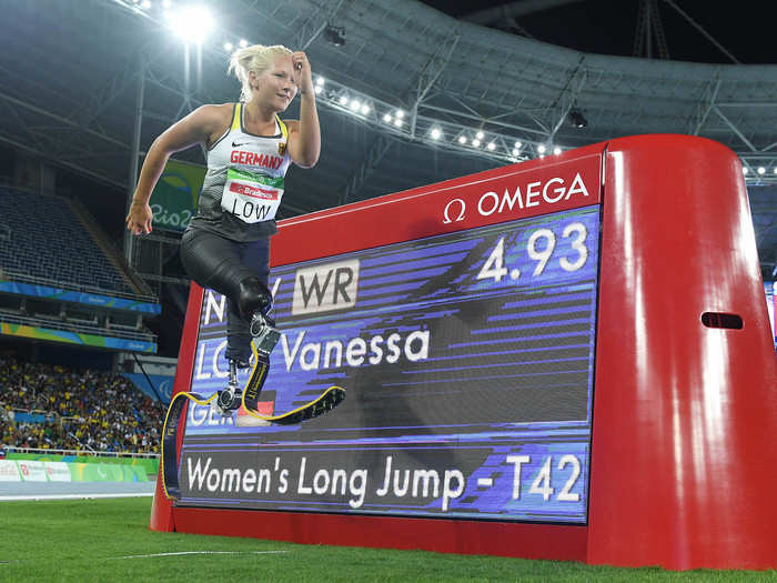 Vanessa Low of Germany poses in front of the scoreboard announcing her world record in the women