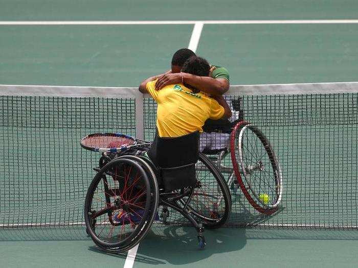 Lucas Sithole of South Africa and Ymanitu Silva of Brazil hug after competing in wheelchair tennis.