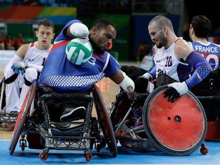 Members of Team France and Team USA compete in mixed wheelchair rugby.