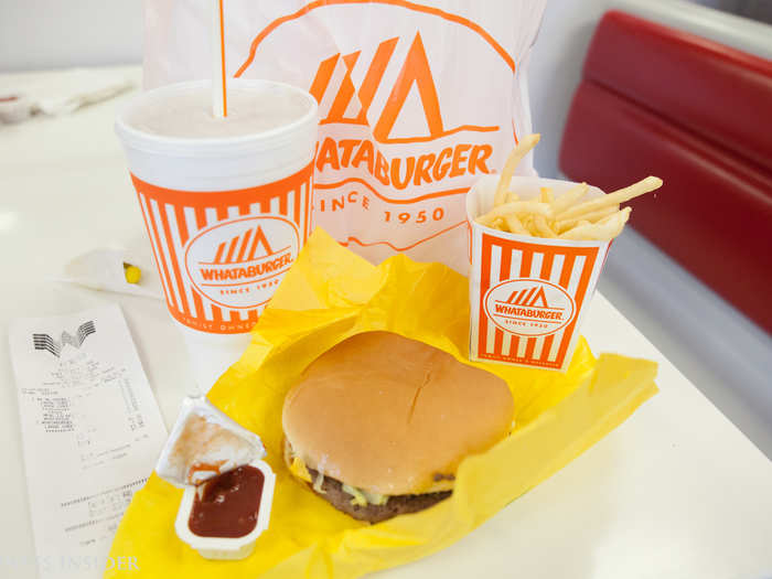 I unwrap my Whataburger order, the classic double-meat-and-cheese Whataburger with no substitutes or add-ons. The fast-food chain always boasts that its patties are never frozen and are 100% pure American beef patties.