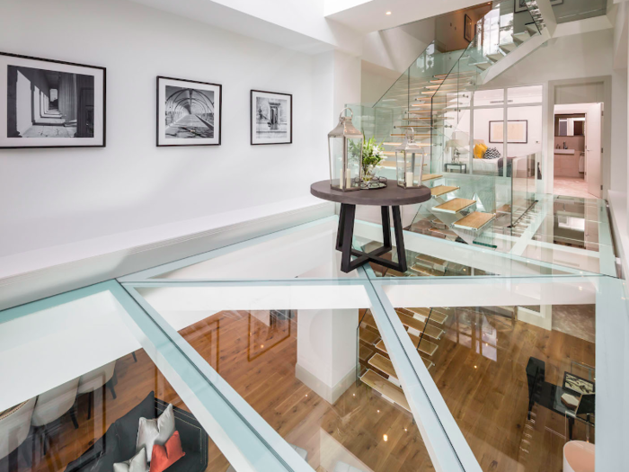 Wetherell says that the glass floor was created from double layer of wedge shaped, 5 inch thick slabs of structural glass supported on beams, to give a dramatic view of the grand reception room below.