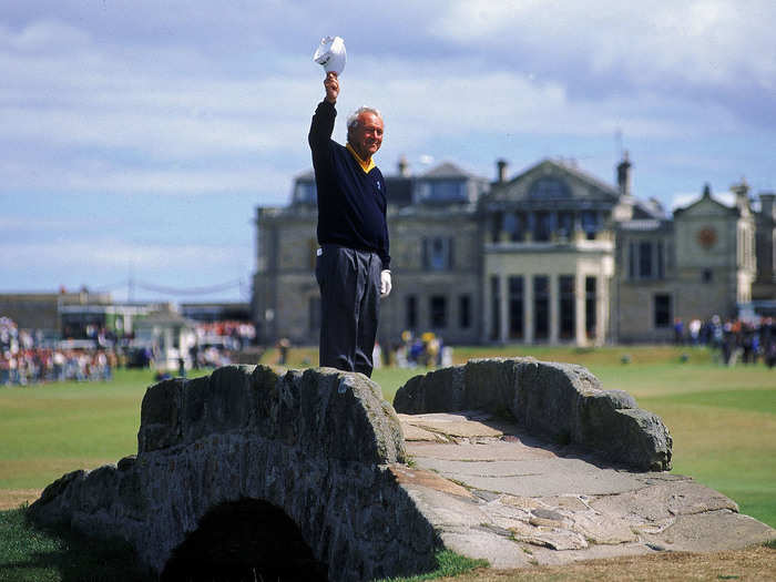 Palmer waves to the crowd from Swilken Bridge at St. Andrews in Scotland in 1995. It was the final time Palmer would play in the Open Championship.