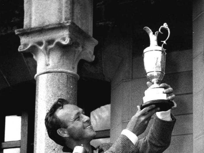 Palmer lifts the Claret Jug after winning his second-straight Open Championship in 1962.