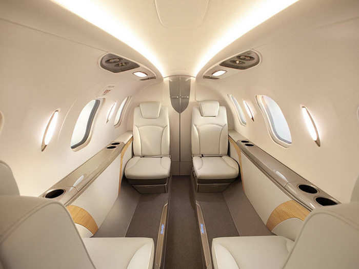 The cabin seats four people comfortably with the option to include a side-facing fifth seat. Because the engines are mounted over the wings, the plane offers more cargo space — a total of 66 cubic feet. The seats can slide along a track the length of the cabin to expand passengers