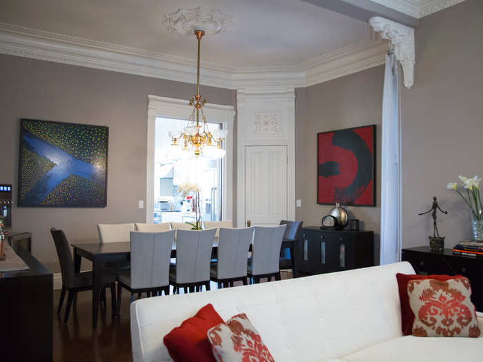 The family took down a wall to create a more open-concept feel. A red, black, and white color scheme carries from the formal dining room to the parlor.