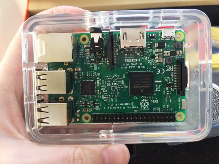 The Raspberry Pi locks into a protective case. On the left side, there are several USB ports, a speaker jack, and an HDMI port.