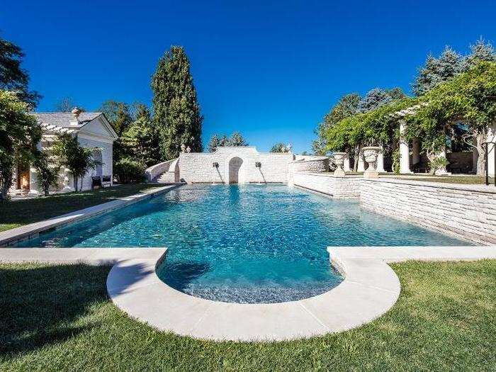 A separate swimming pool is set with limestone and surrounded by pool houses and a changing area.