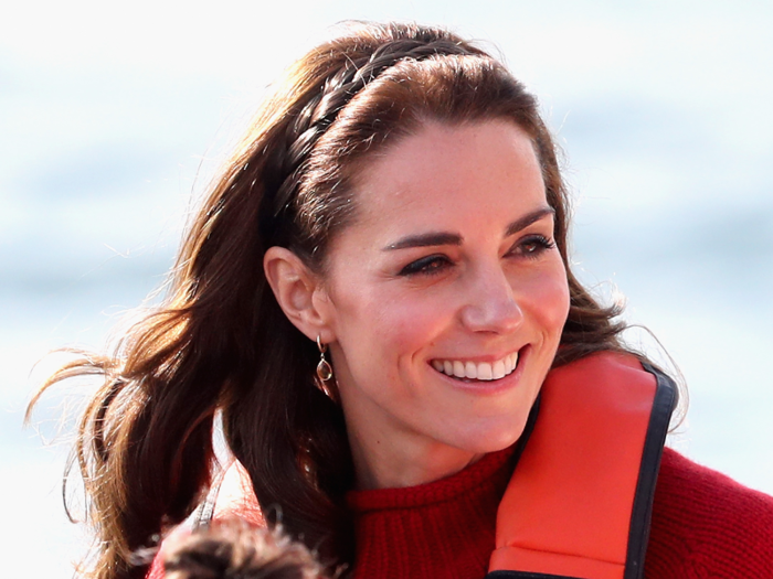 Here she is during a fishing trip in Haida Gwaii, sporting a simple red sweater and a delicate braided hairstyle.