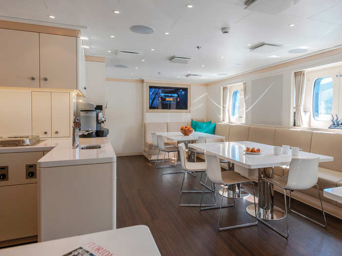 A dining area with a TV and kitchen space...