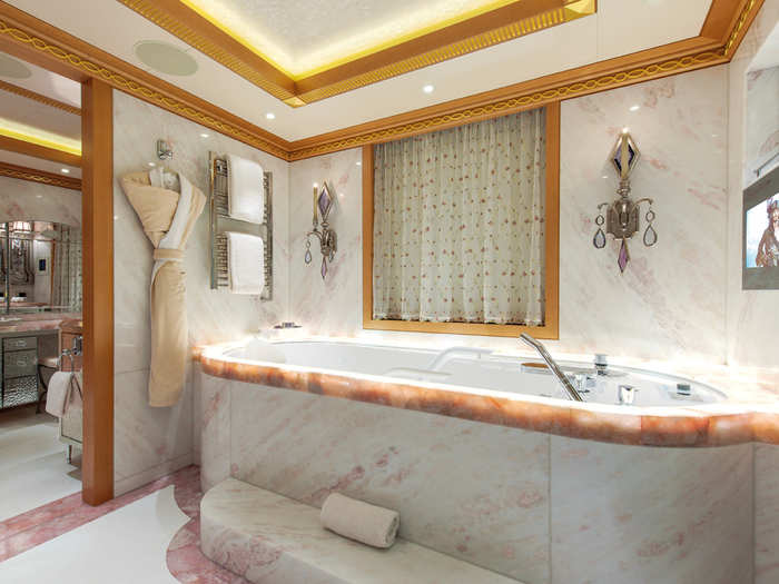 In addition to a walk-in shower, the master bathroom also has a giant, marble bathtub.