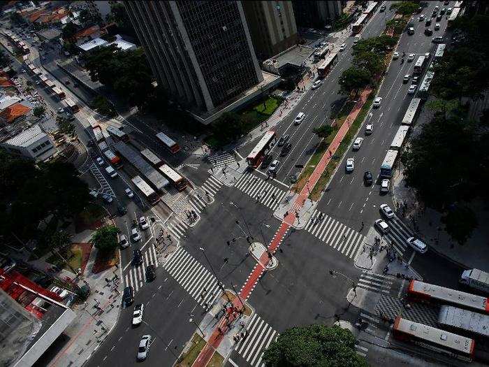 Traffic lanes and parking take precedent over green spaces and outdoor seating. People traveling on foot are quarantined to tiny sidewalks.