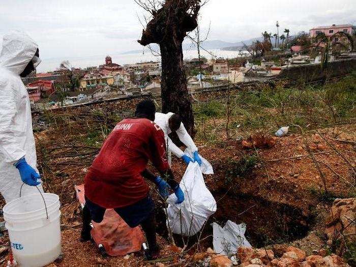 Rescue workers bury the dead.