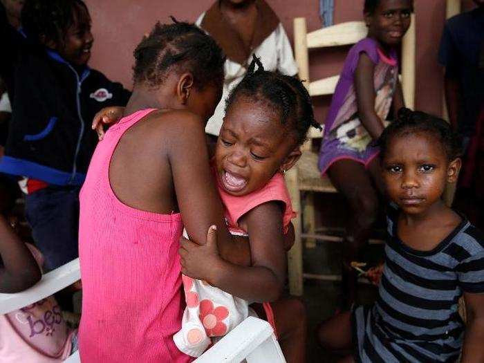 A girl cries as she stays with her relatives at a partially destroyed school.