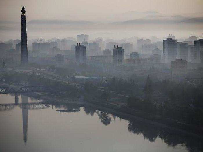 On the other side of the city, the 558-feet-tall Juche Tower looms above the Taedong River.