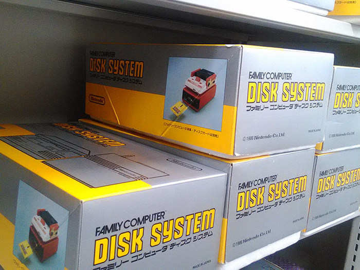 Check out this shelf. Nintendo just has a shelf full of mint-condition, boxed Famicom Disk Systems at Nintendo HQ. It was sold separately as an add-on for the Famicom after launch.