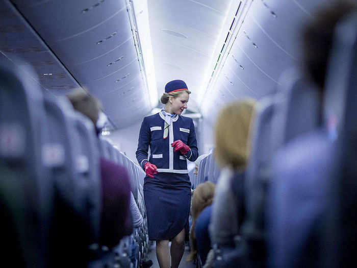 A Norwegian flight attendant checks in on customers in 2015.