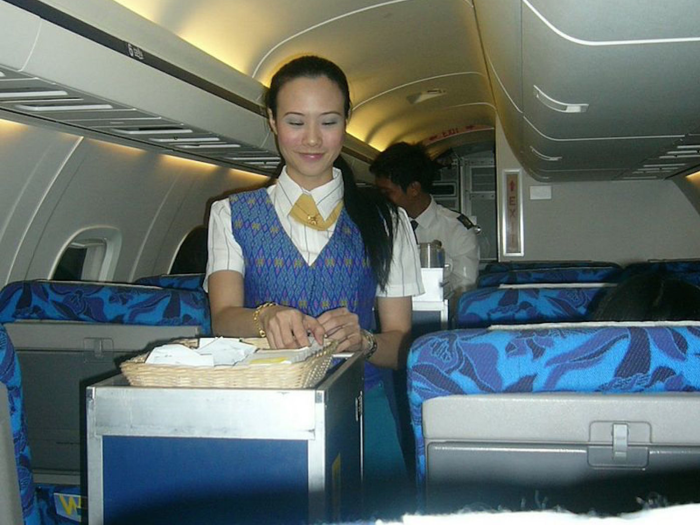 A PBair flight attendant distributes snacks during a 2004 flight.