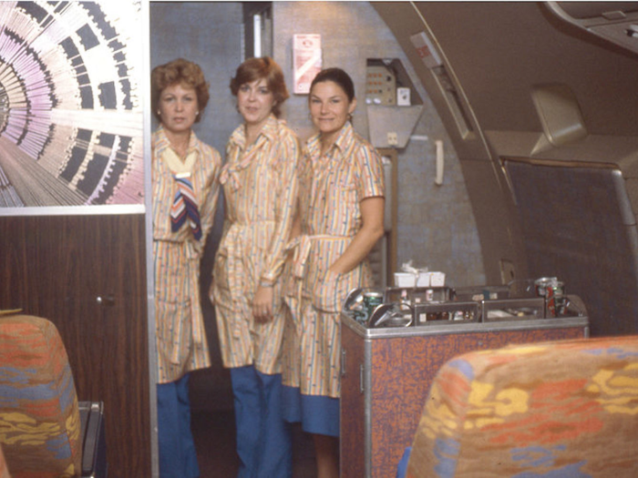 Eastern airlines flight attendants check in on the first class cabin in 1980.