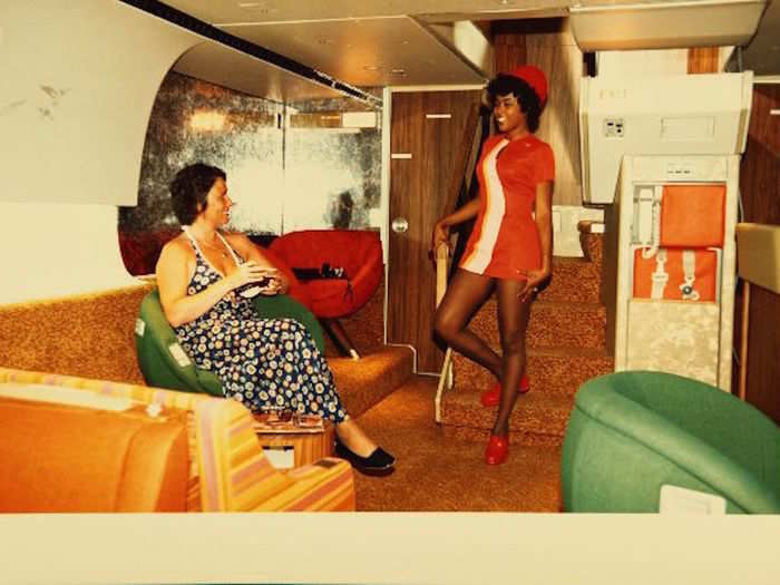 A PSA flight attendant greets a first class customer.