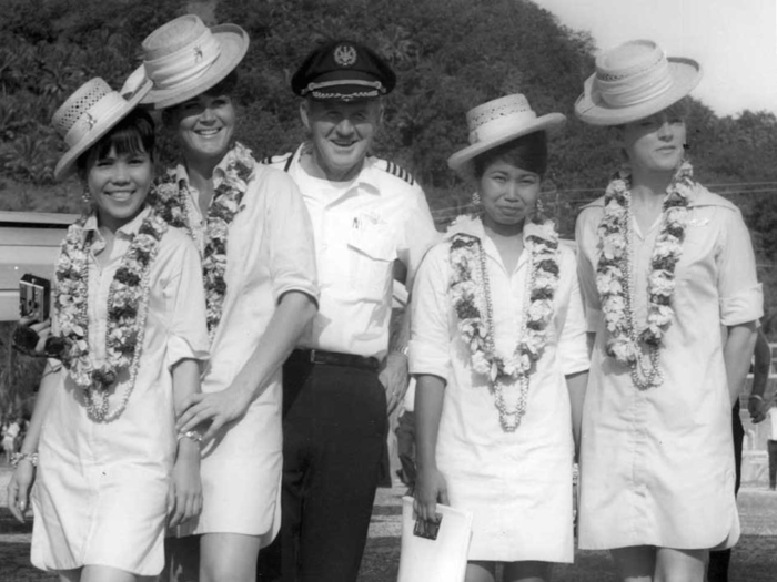 Air Micronesia stewardesses pose with a pilot.